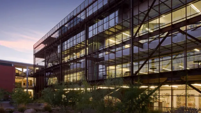 University of Arizona Campus building with glass windows and dark railings taken during dusk