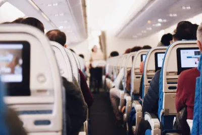Airplane aisle with seated passengers