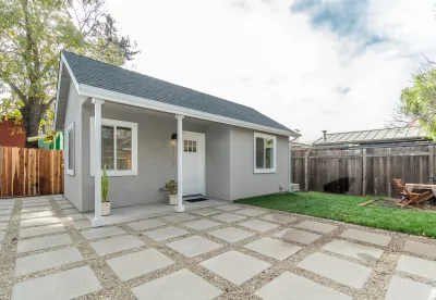 Small grey accessory dwelling unit cottage in California backyard
