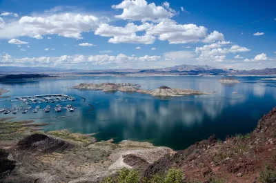 Lake Mead on the Colorado River with boats in a marina and clear low water line.