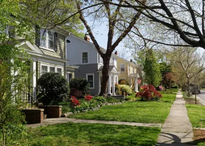 Two-story houses on tree-lined street in Richmond, Virginia