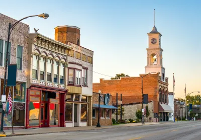 Commercial street in small rural U.S. town with storefronts and clocktower.