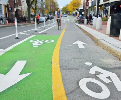 Two-way green painted bike lane in city.