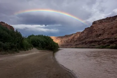 Rainbow over red rocks and river in Utah's Labyrinth Canyon.