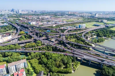 Aerial view of five-level freeway interchange in Houston, Texas with bridges spanning green bayou.