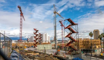Large construction site with red staircases and cranes near downtown Los Angeles, California.