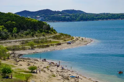 Aerial view of blue Canyon Lake reservoir beach in Texas on sunny day.