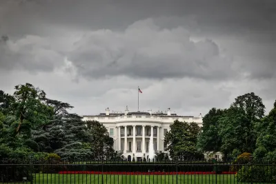 Front of White House with stormy sky above.