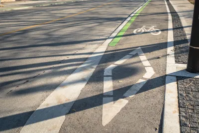 Painted bike lane with bike symbol and diamond on street in downtown Toronto, Ontario.