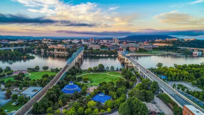 Aerial view of Chattanooga, Tennessee with two bridges over river in background.