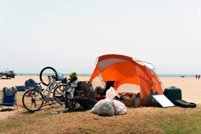 Orange tent and bicycles belonging to unhoused people at Venice Beach, California