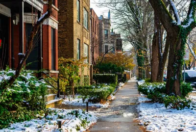 Chicago sidewalk with brick homes in winter.