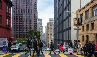 People crossing street at crosswalk in downtown San Francisco, California