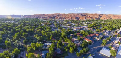 Aerial view of Moab, Utah with red mountains in background.