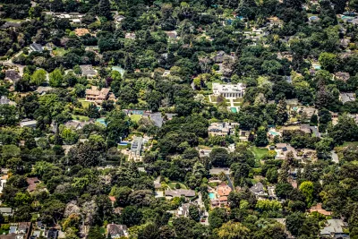 Aerial view of large houses in large yards surrounded by trees in Palo Alto, California