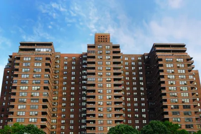 Looking up at red brick public housnig high-rise building in New York City