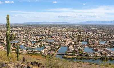 View from hilltop of Glendale, Arizona with saguaro cactus in left foreground.