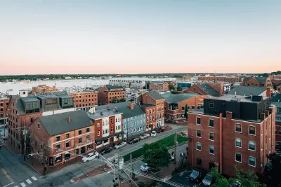 Aerial view of mid-rise brick buildings in Portland, Maine on waterfront.