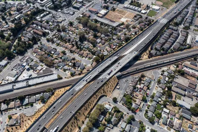 Aerial view of 238 freeway in Oakland, California cutting through neighborhood with small houses