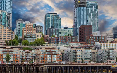 View of dense apartment buildings on Seattle waterfront with high-rise buildings in background.