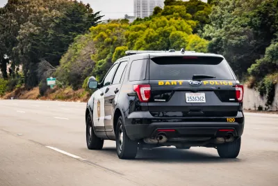 View from back of BART Police SUV driving down street in San Francisco, California.