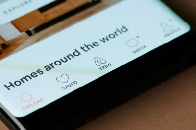 Close-up of phone screen with Airbnb app screen