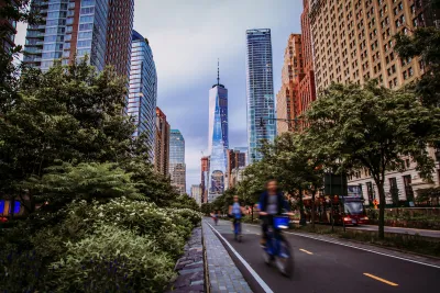 Blurred view of cyclists riding in protected bike lane