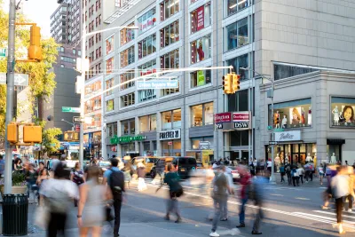 Blurred people walking through busy crosswalk in Manhattan.