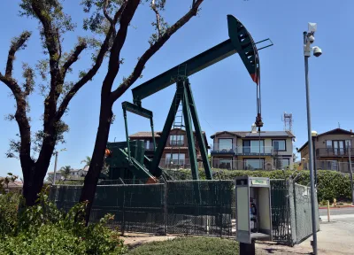 Fenced-in oil pump in residential neighborhood