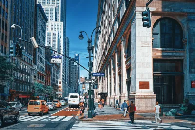 Busy street with red painted bus lane in midtown Manhattan, New York City.