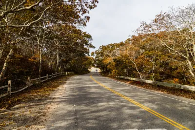 Route 6 highway in Massachusetts with fall trees on either side