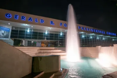 Exterior of Gerald Ford Presidentail Library with fountain at night.
