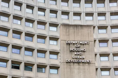 Close-up of office building with windows and sign for Department of Housing and Urban Development in Washington, D.C.