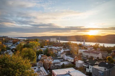 Aerial view of small town in Hudson Valley, New York State with river at sunset.
