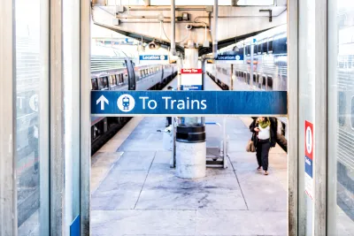 Close-up of 'To Trains' sign above blurred train platform in Washington, D.C.