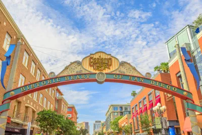Arched entrance sign over street to San Diego's historic Gaslamp Quarter with slogan "historic heart of San Diego."
