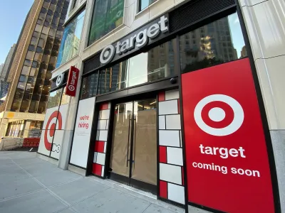 Storefront of small Target in New York City with "coming soon" and "now hiring" signs in window.