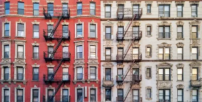 Facade of brick multistory apartment buildings in New York City with fire scapes.