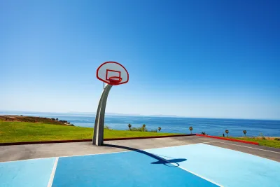 Beachside basketball couty with ocean view and blue painted court at Angel Gate Park in Los Angeles, California on a sunny day