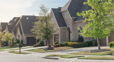 View of brick two-story houses in Dallas suburb