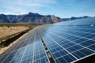 Solar panel array with Mojave Desert mountains in background.