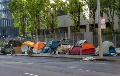 Tents set up by unhoused people on sidewalk in San Francisco, California.
