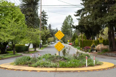 Roundabout with landscaping in middle in residential street.