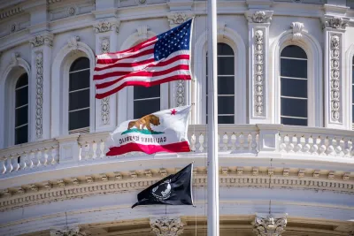 Close-up of U.S., California, and POW-MIA flags on California state capitol dome.