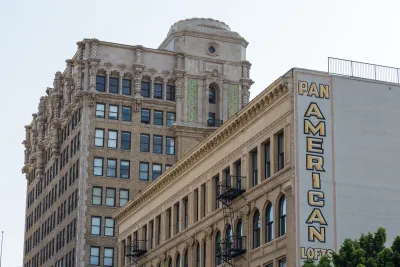 Historic buildings in downtown Los Angeles with large "Pan American Lofts" sign on side of building.