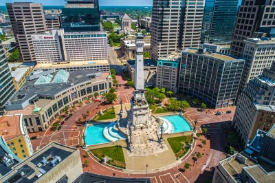 Aerial view of Monument Circle with tall statue on post in middle of traffic circle area in Indianapolis, Indiana