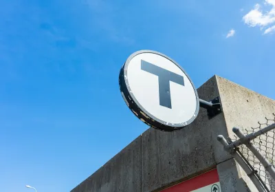 CLose-up of MBTA "T" logo on building.