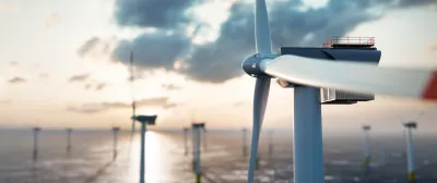 Close-up of offshore wind turbine with other turbines in background.
