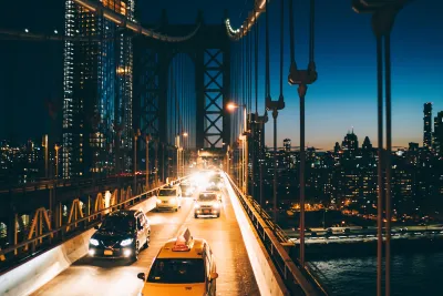 View of traffic on bridge going into Manhattan, New York City at night.