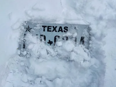 Texas license plate almost entirely covered by snow